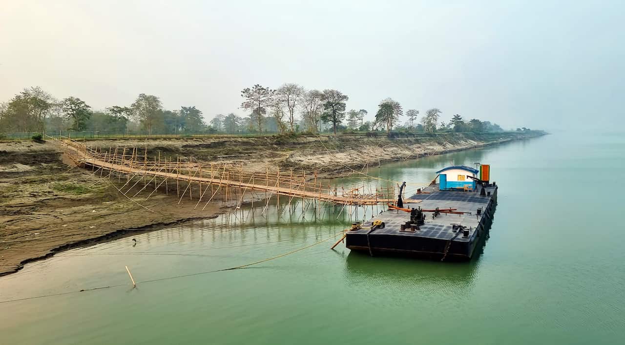 The pontoon and its bamboo footbridge on the Brahmaputra River in Silghat, Assam, India.