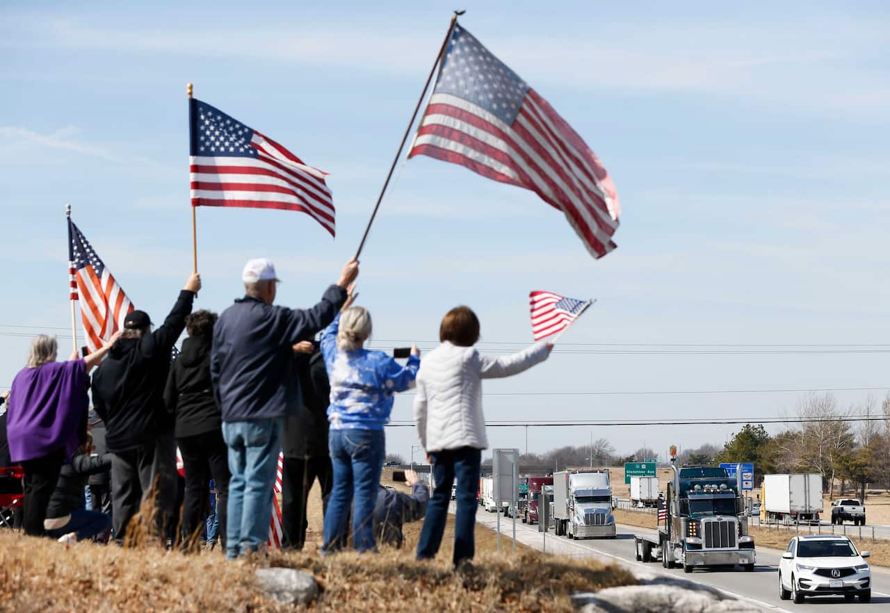 More than 100 people gather along I-44 at Crossway Baptist Church in northeast Springfield to support The People's Convoy as it passed through Springfield on its way to Washington DC.