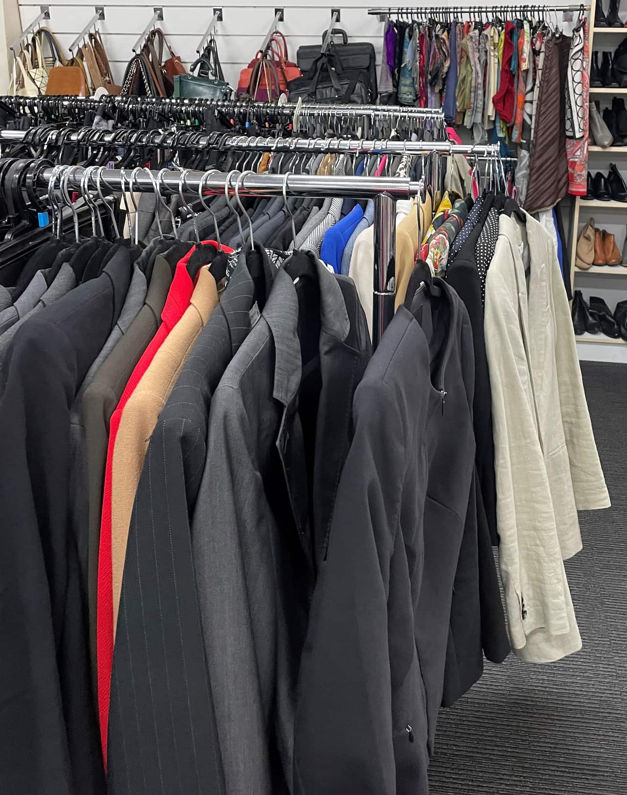 Clothes hanging on racks at a charity.