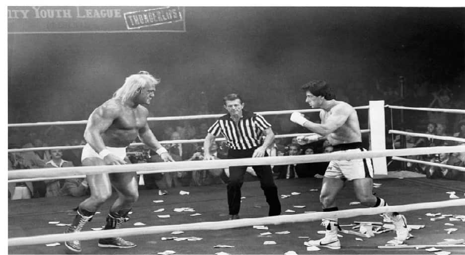 Black-and-white picture of Hulk Hogan (left) and Sylvester Stallone (right) in a boxing ring for the movie Rocky 3