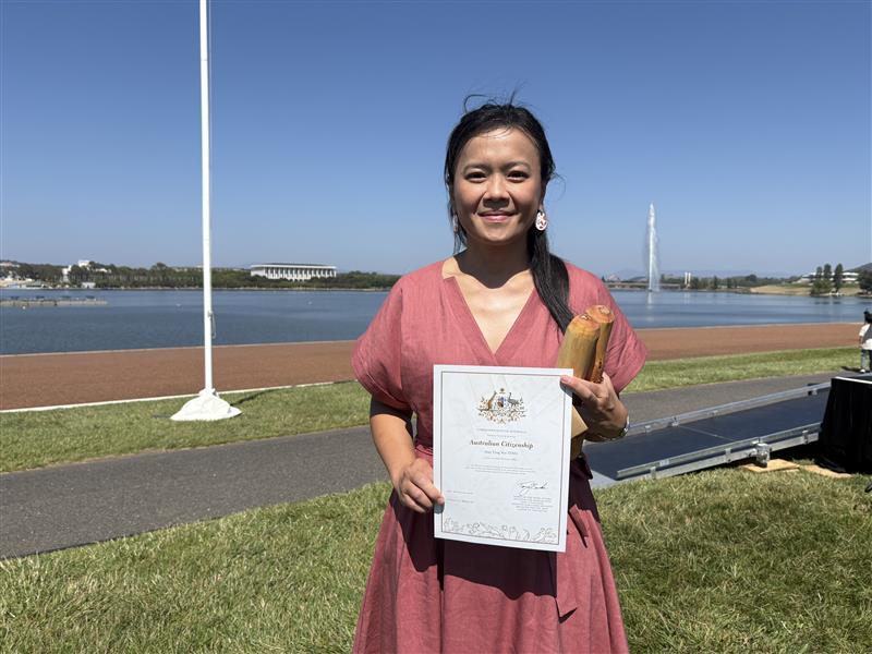 A woman holding a certificate