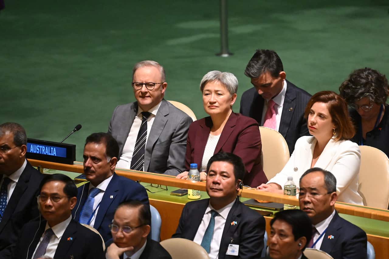 Prime Minister Anthony Albanese, Foreign Minister Penny Wong and Communications Minister Anika Wells sitting at a bench