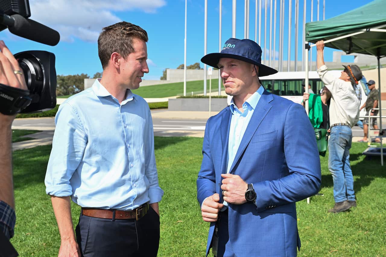 Two men standing outside. 