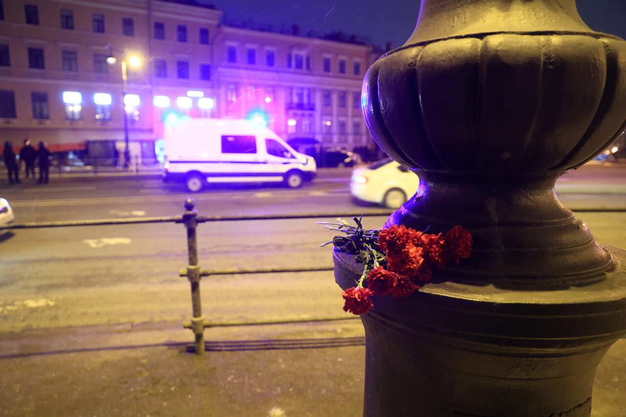 A small bouquet of flowers sits by the street, opposite a St. Petersburg cafe where an explosion occured.