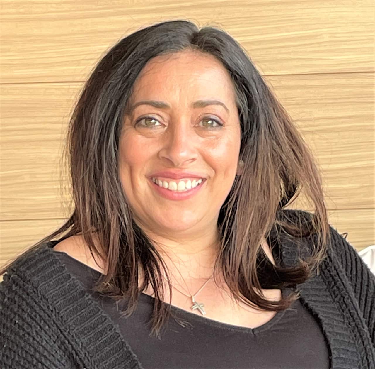 A woman in a black top sitting.