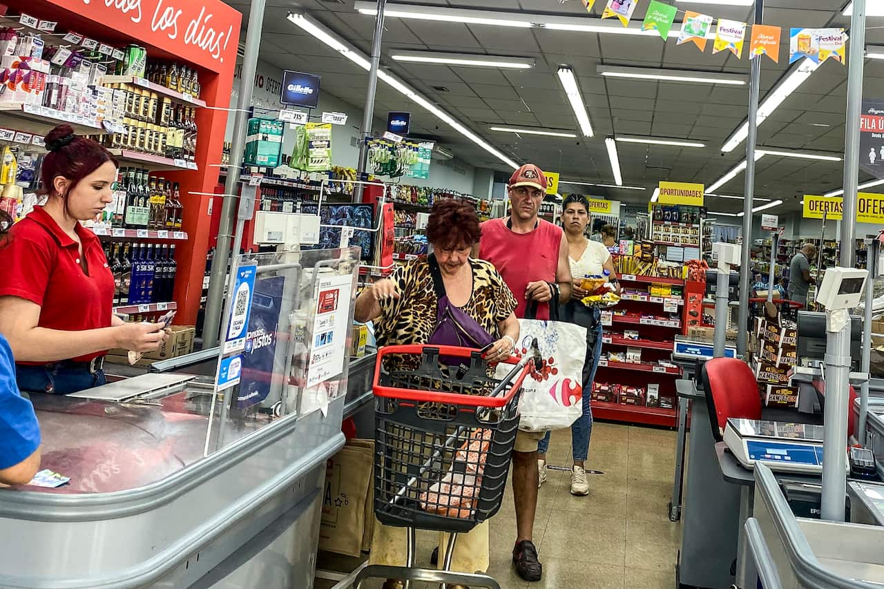 Customers in line at a grocery story in Argentina.