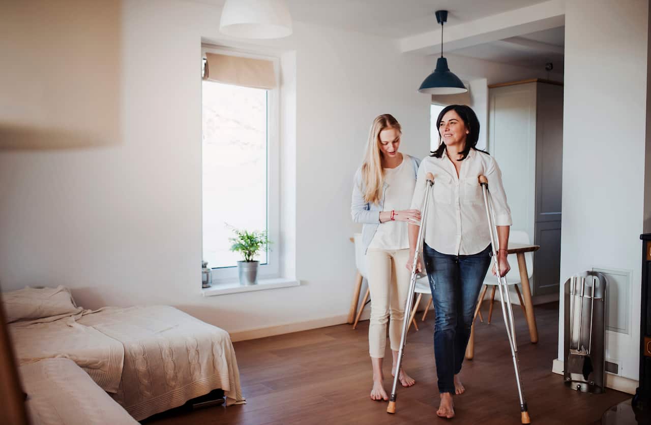 SG Carers Support - Daughter helping her mother to walk with crutches