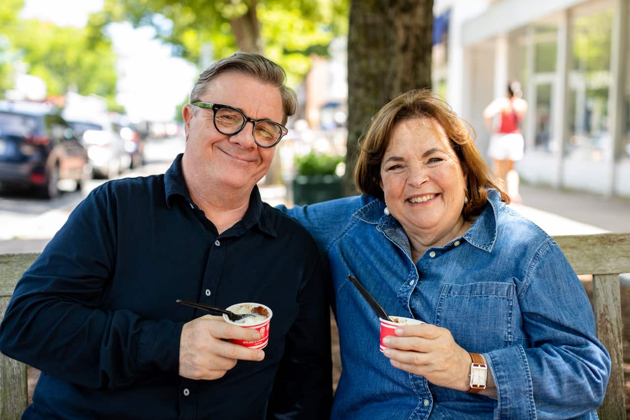 Ina Garten and Nathan Lane sit on a park bench with gelato