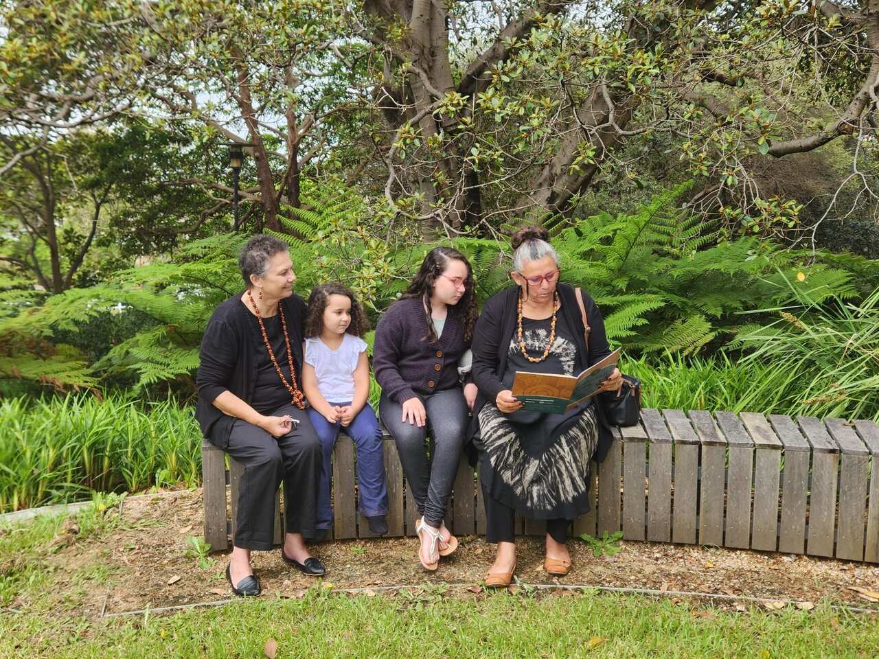 Aunty Diane Riley-McNaboe and Aunty Lynette Riley sit and share their language with their grandchildren
