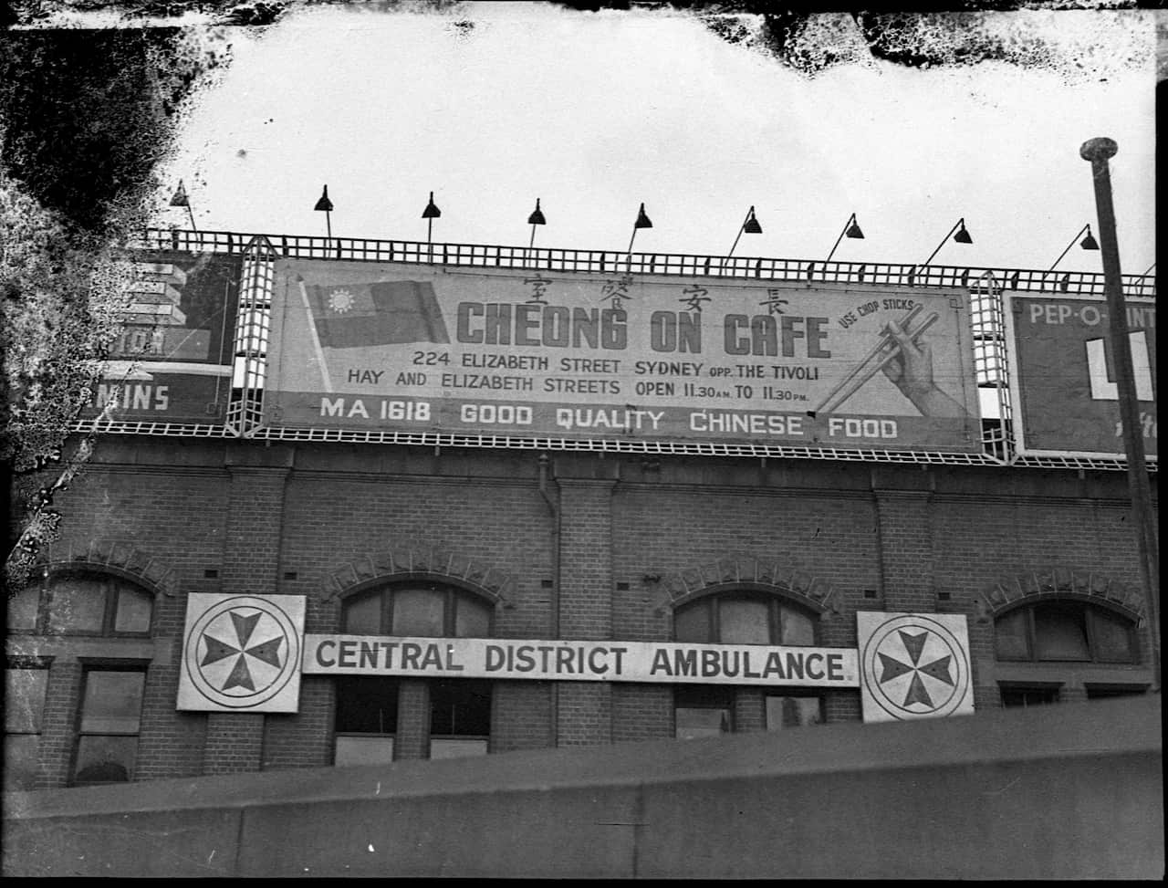 A black and white photo of an advertising sign for Cheong On Cafe in Sydney