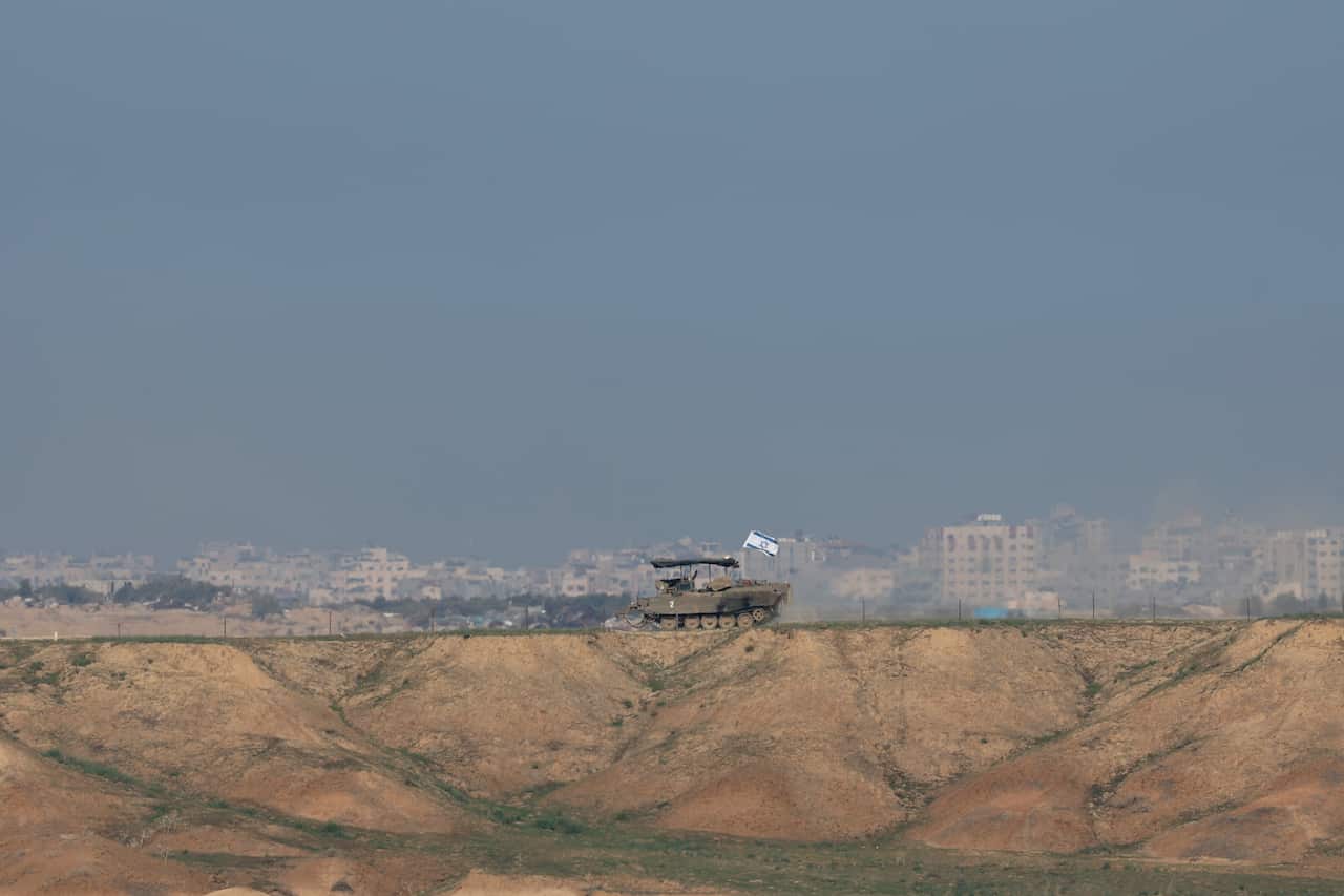An armored vehicle of the Israeli army patrols an area near Gaza.