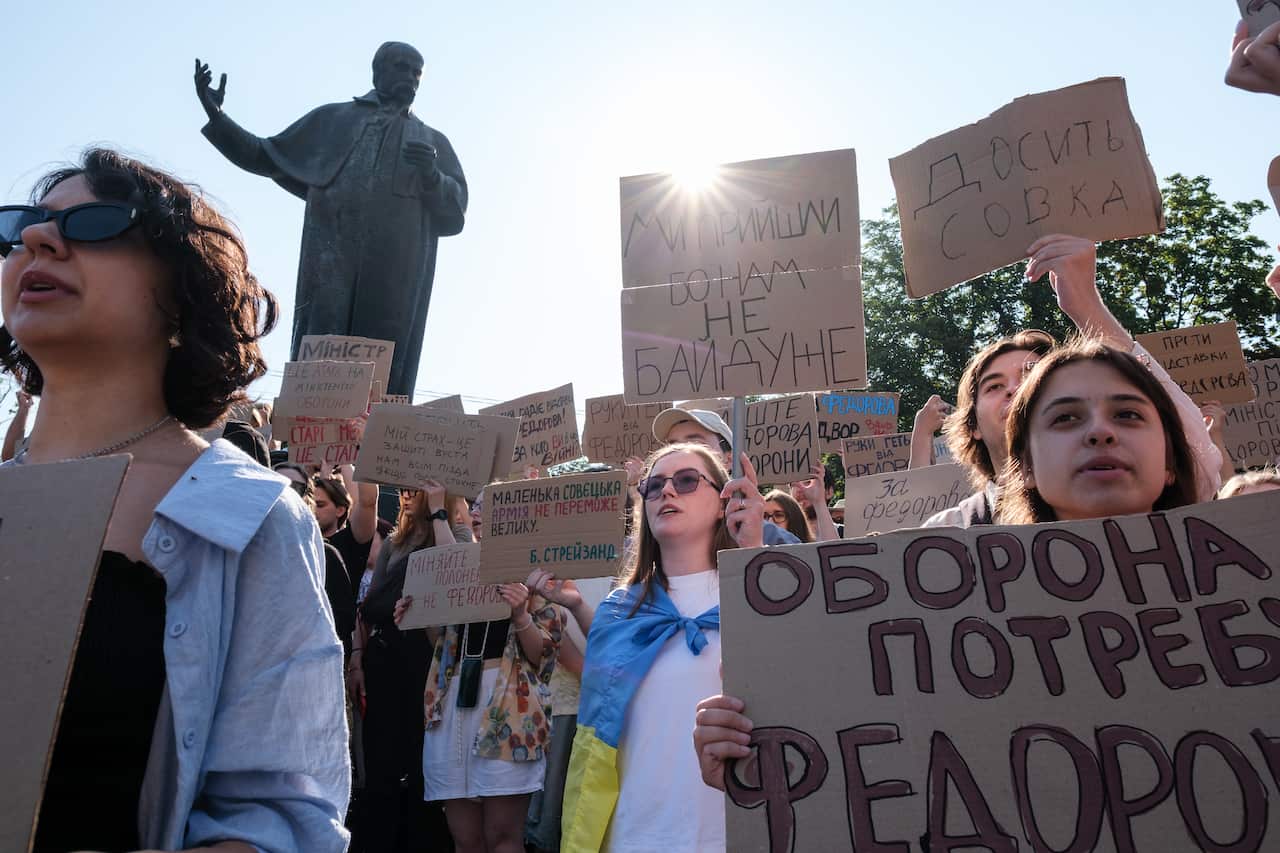 Protesters holding signs.