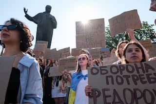 Protesters holding signs.