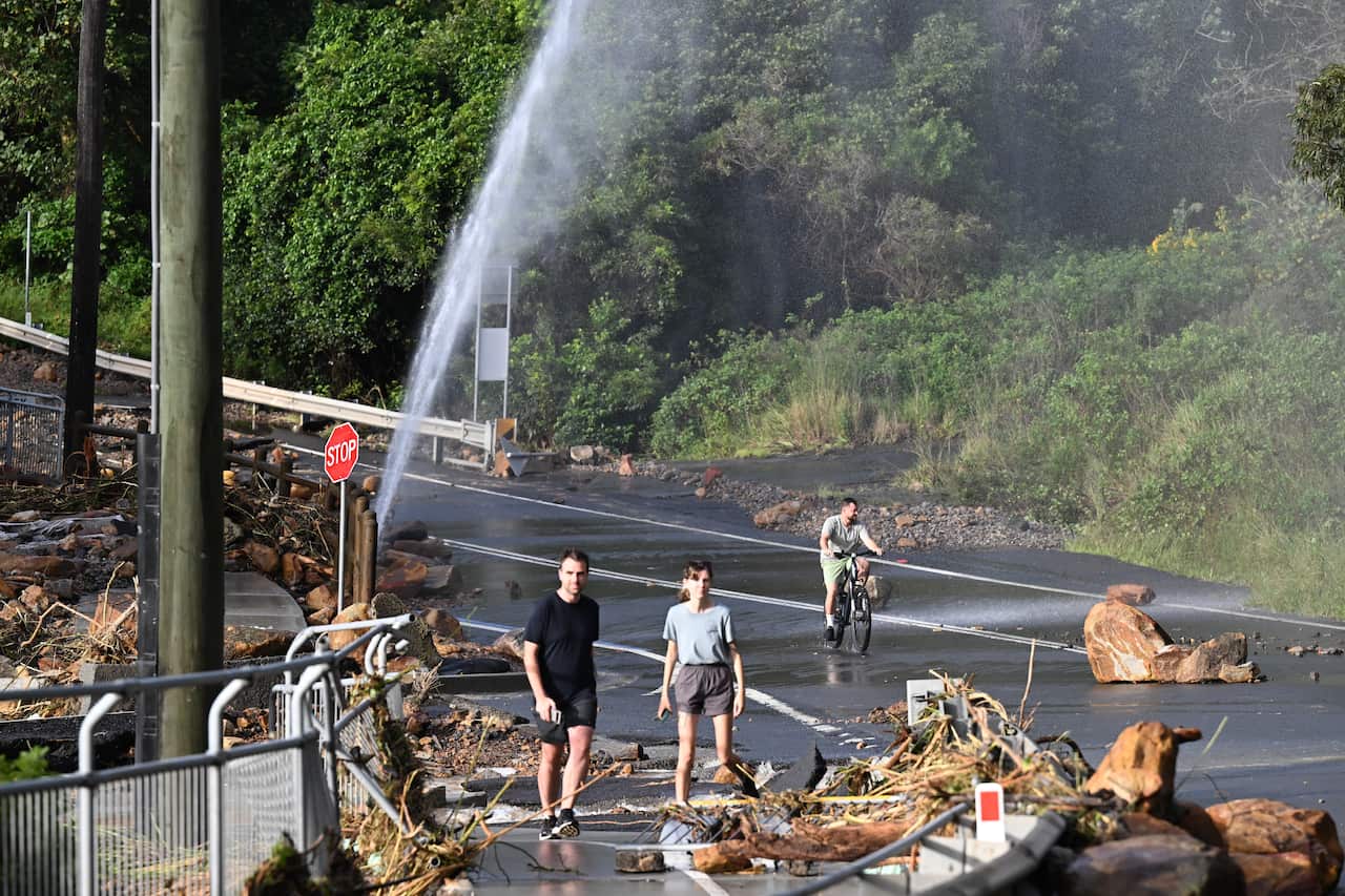 A burst pipe spills onto a road.