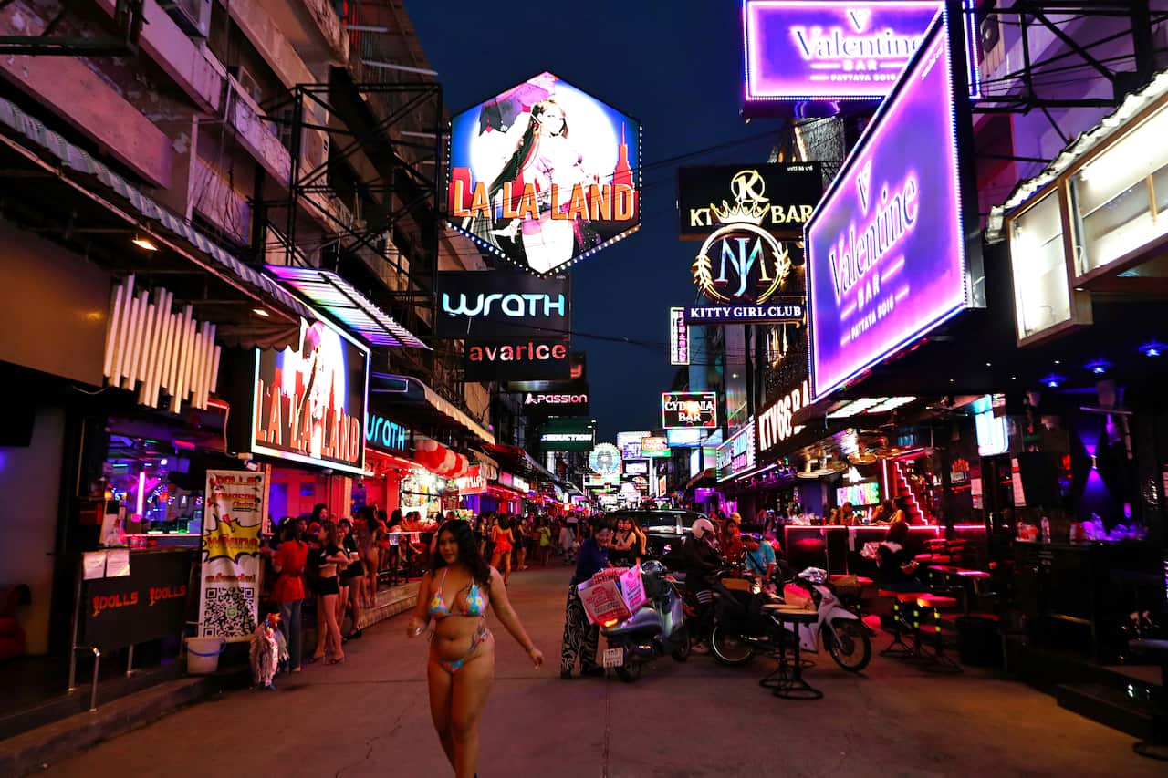 A busy street in Thailand with colourful neon signs