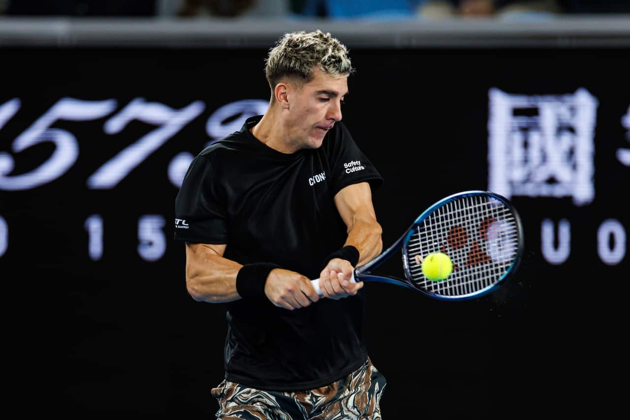 A tennis player hits a shot during a match.