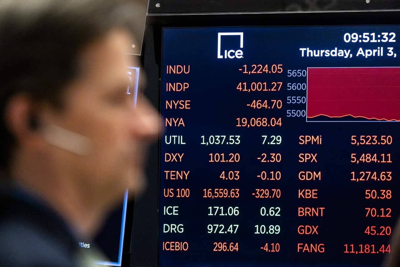 A screen showing the Dow Jones Industrial Average and a person out of focus