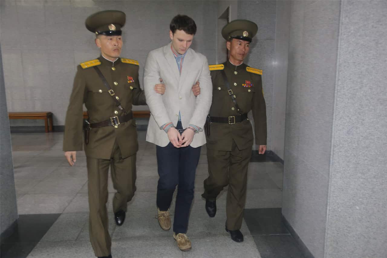 Otto Warmbier being escorted by North Korean officials