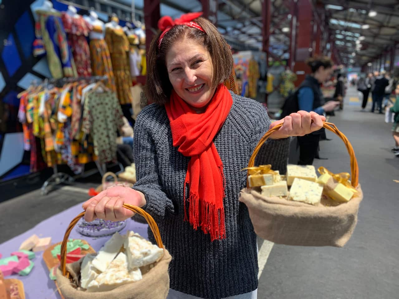 New market stallholder Salma Chami holds a basket of soap