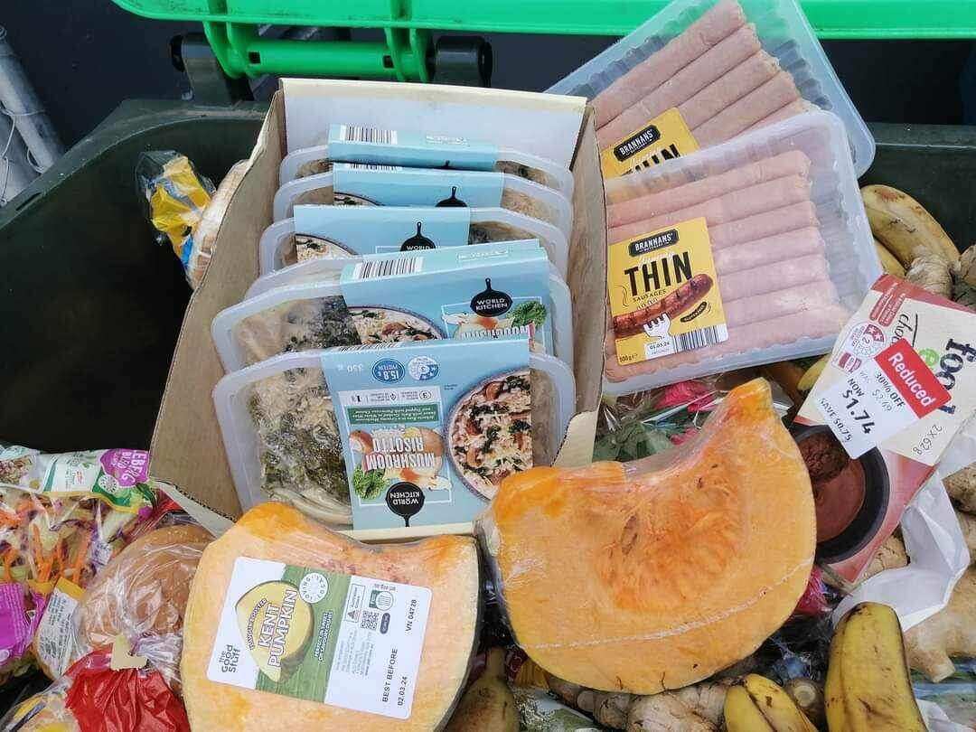 Close up shot of pumpkins, sausages, bananas, coleslaw, burger buns and other food items all in their packages