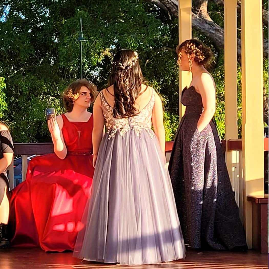 Emmey wearing a dress at her formal with her friends 