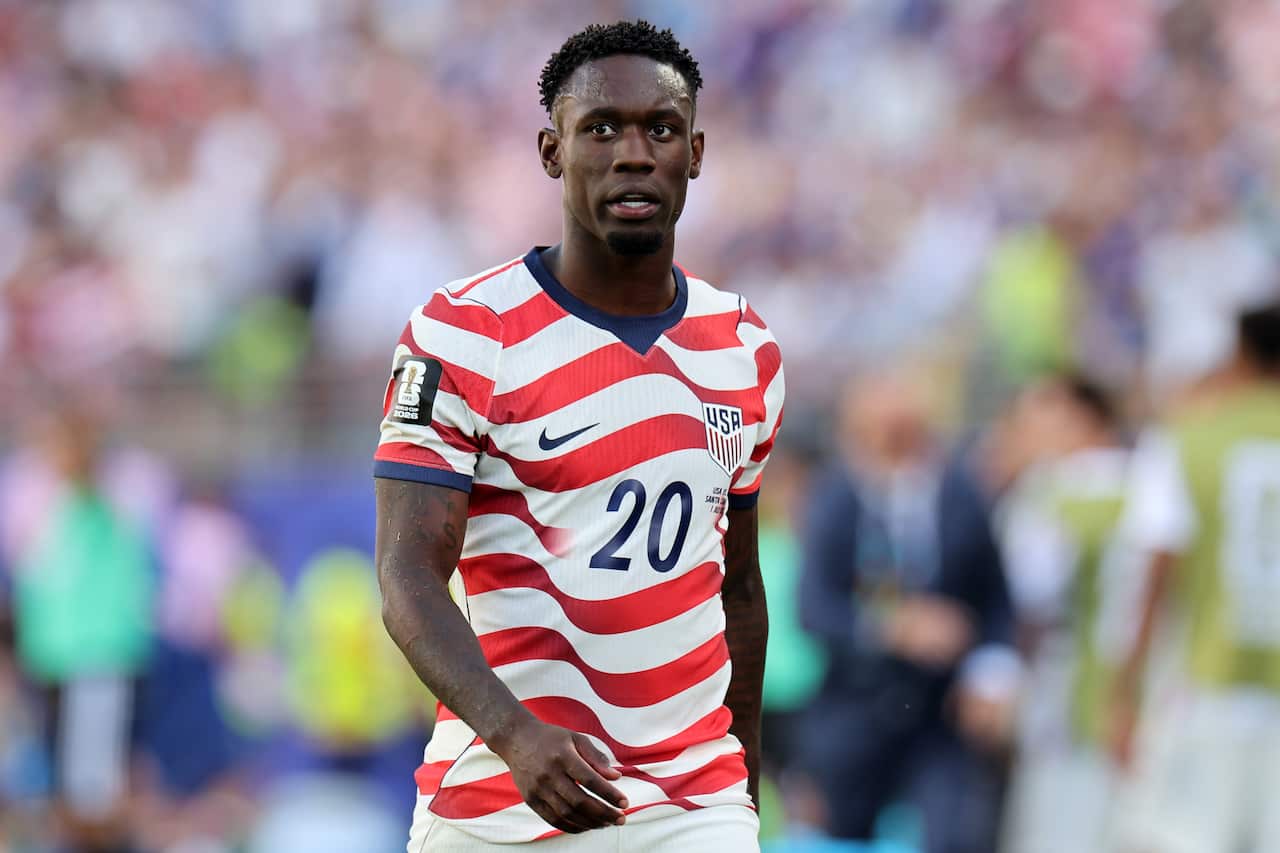 USA football player Folarin Balogun dressed in his team's red and white striped uniform.