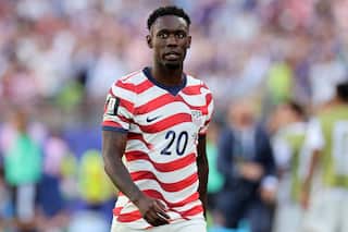 USA football player Folarin Balogun dressed in his team's red and white striped uniform.