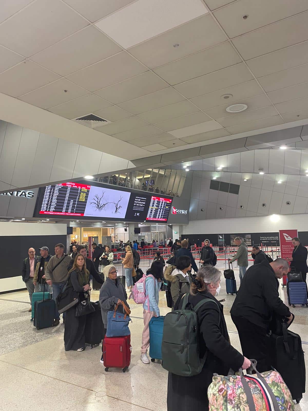 A crowd of people lining up at the airport