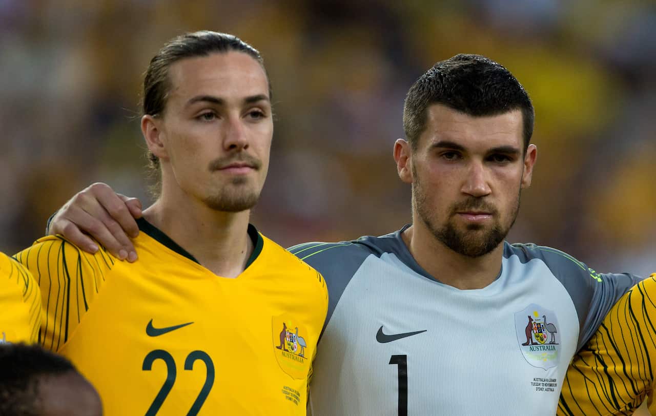 Two footballers in a team line-up