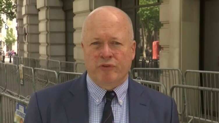 A bald man in a suit and tie.