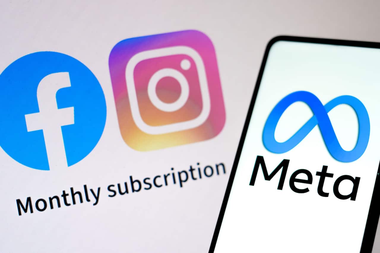 The Meta Platforms logo is seen displayed on a smartphone and the words "Monthly subscription" and logos Facebook and Instagram.