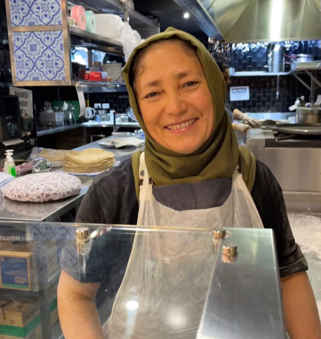 Yakut Hamayoun standing at the counter in Kabul Social.