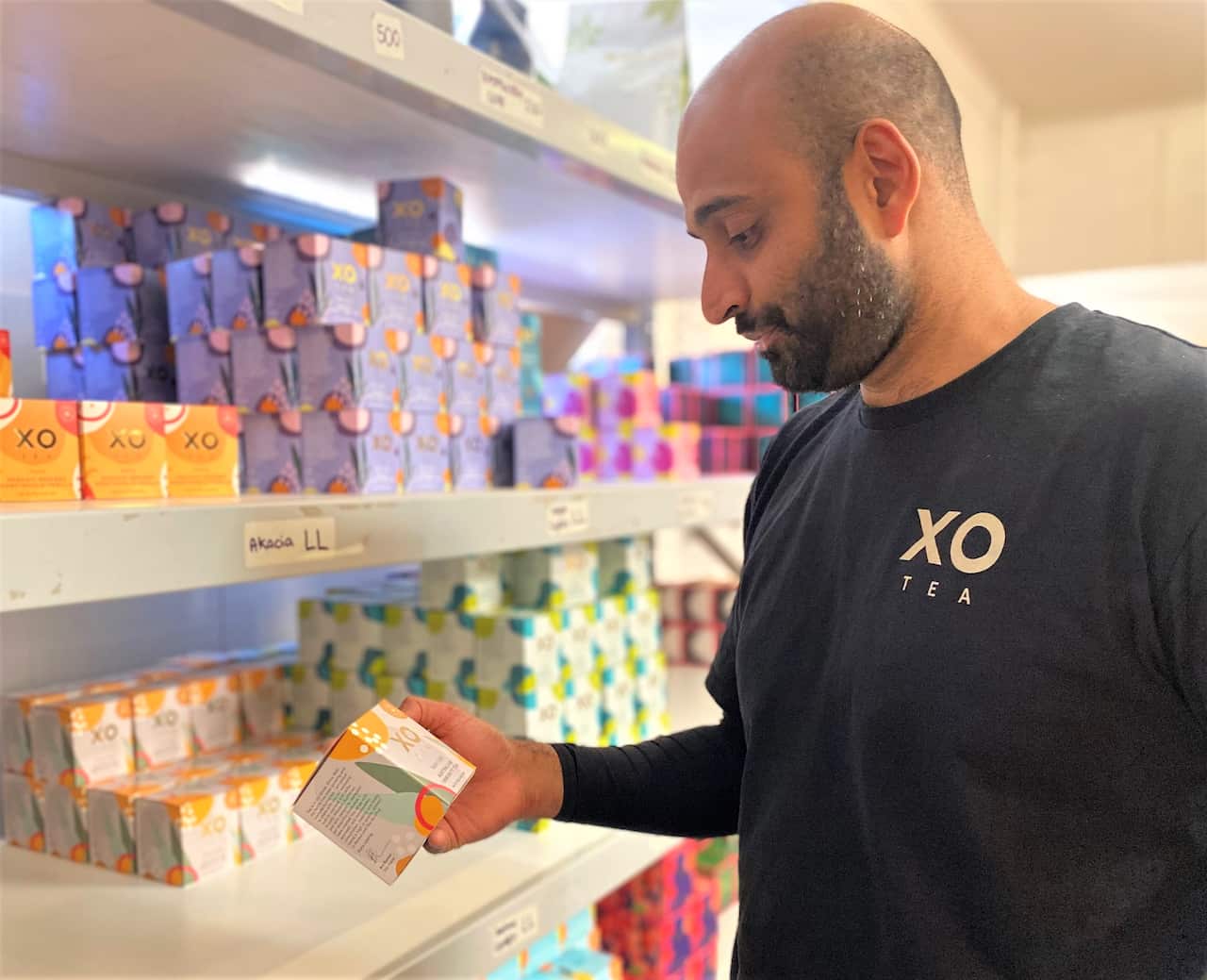 Arjun Kumar holding a box of tea 