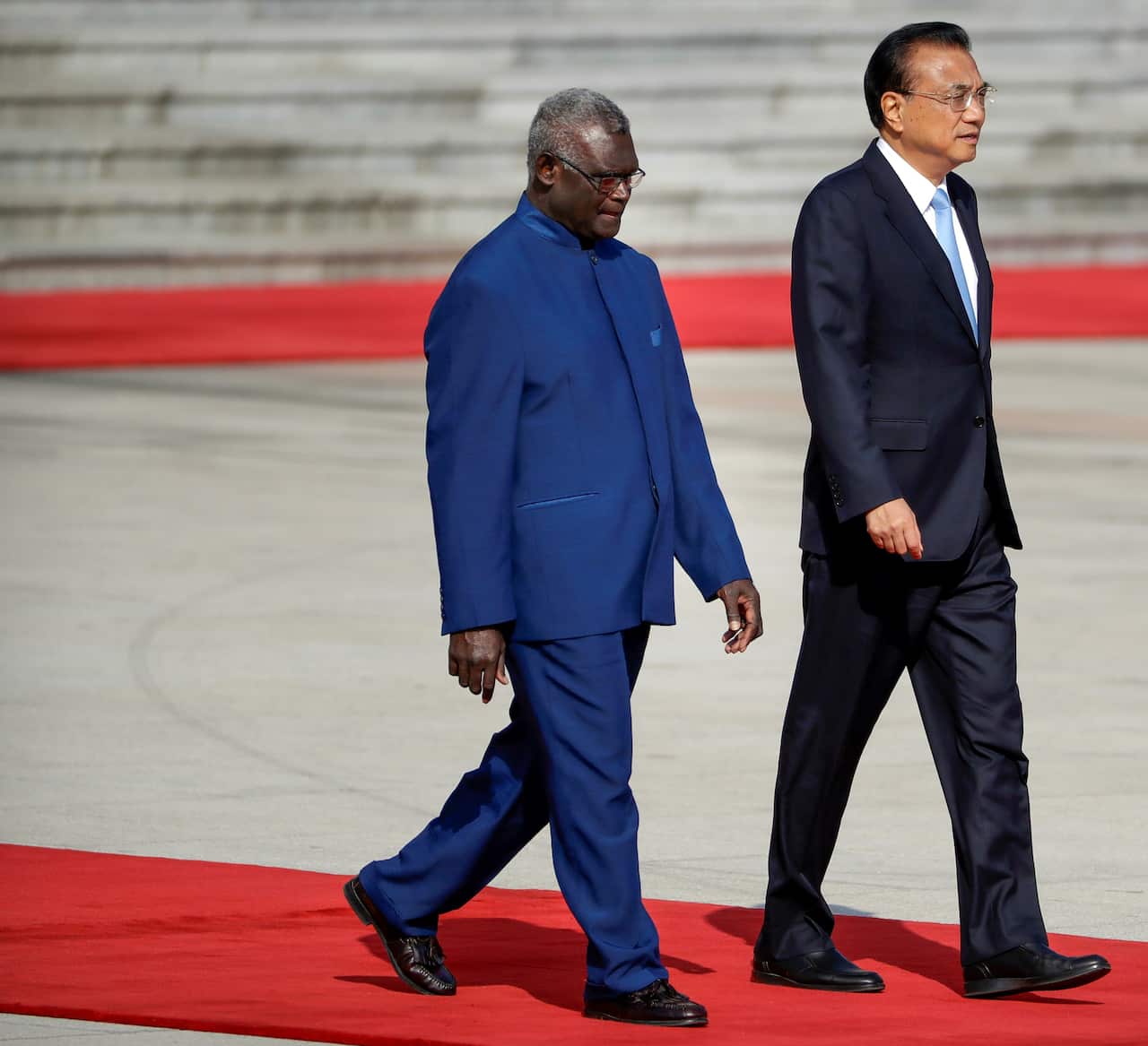Solomon Islands Prime Minister Manasseh Sogavare (left) is seen walking with Chinese Premier Li Keqiang.