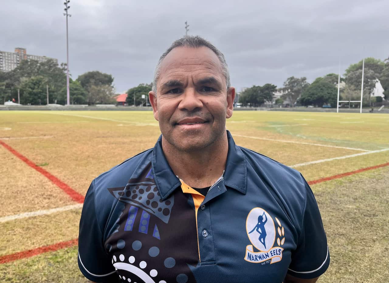 Man standing on footbal field looking at camera