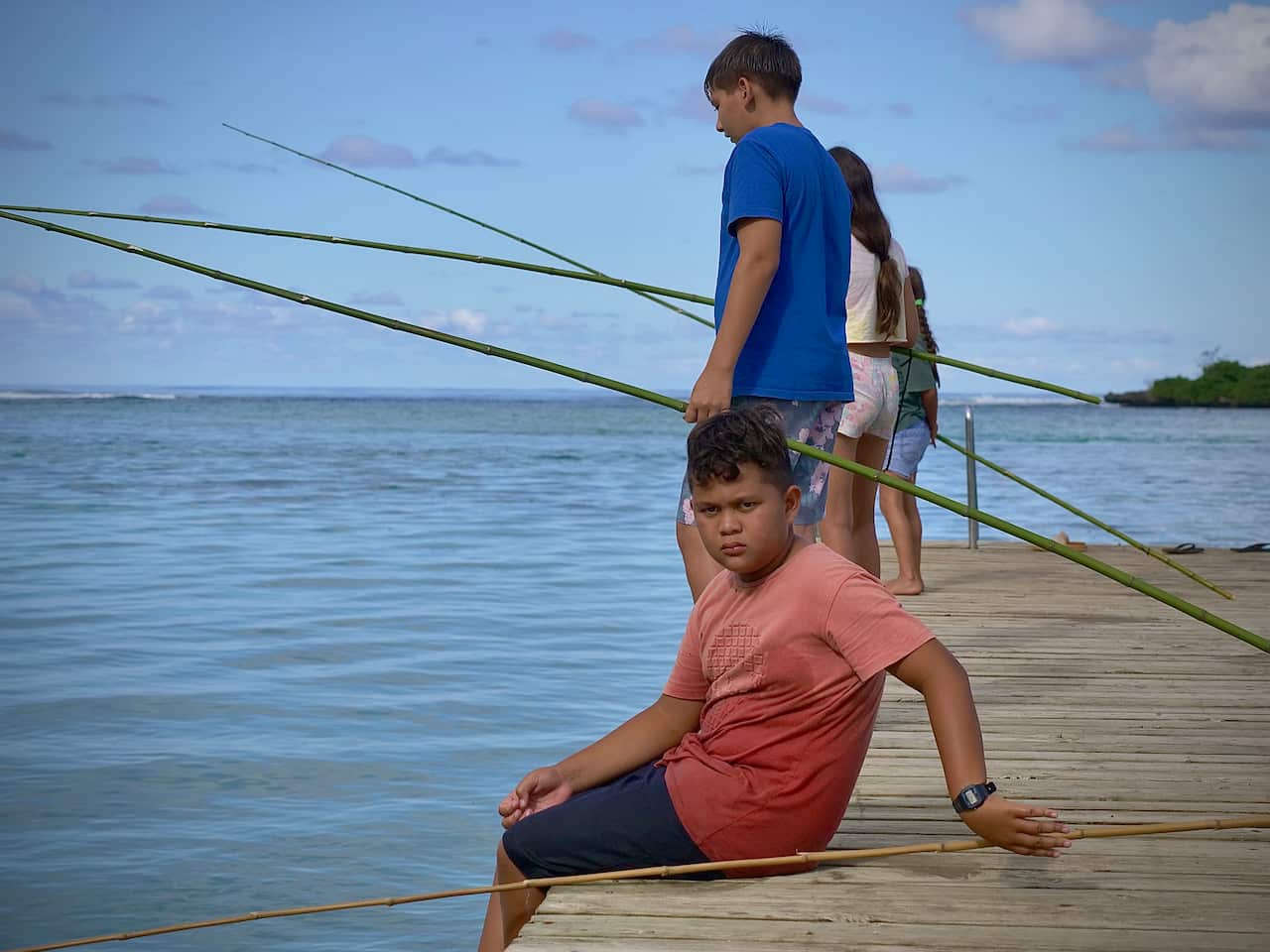 Children fish with traditional poles in Rarotonga.