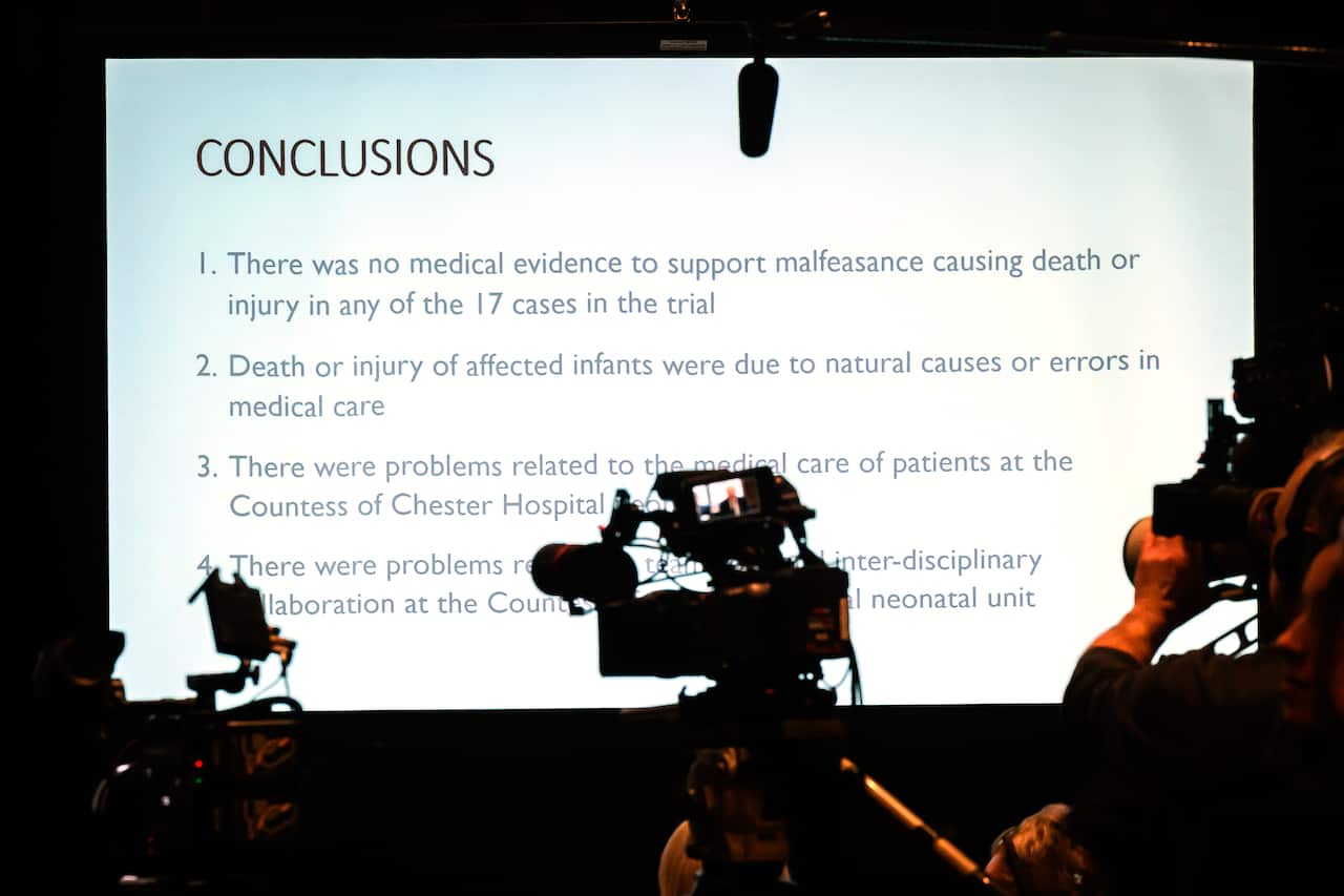 Details of the report on a screen at a press conference.