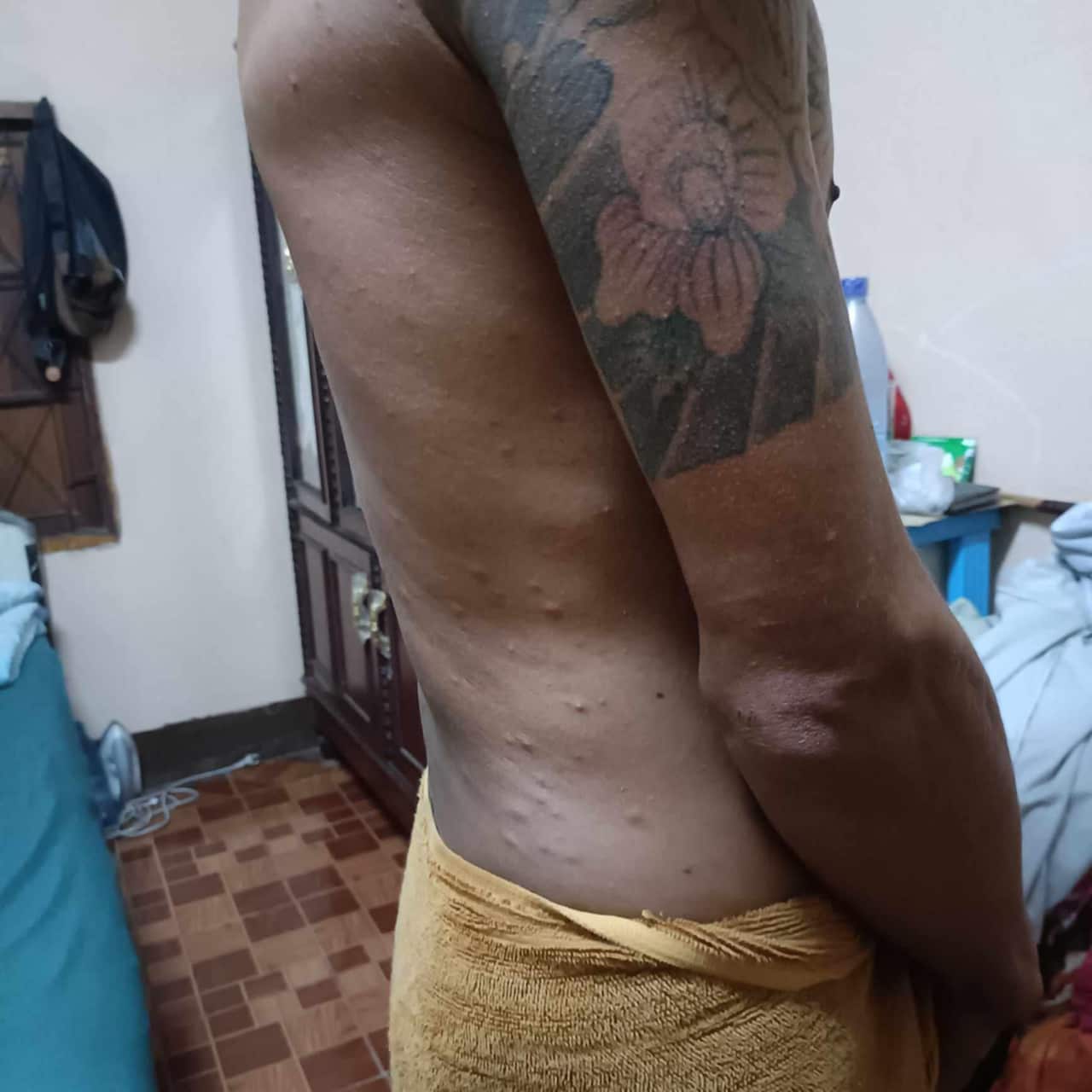 Close-up of a man, showing his bare side