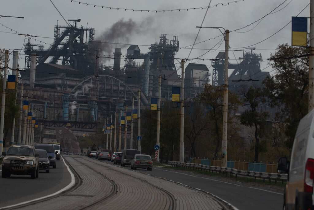 Cars drive by an Azov Stal steel plant avenue in in Mariupol