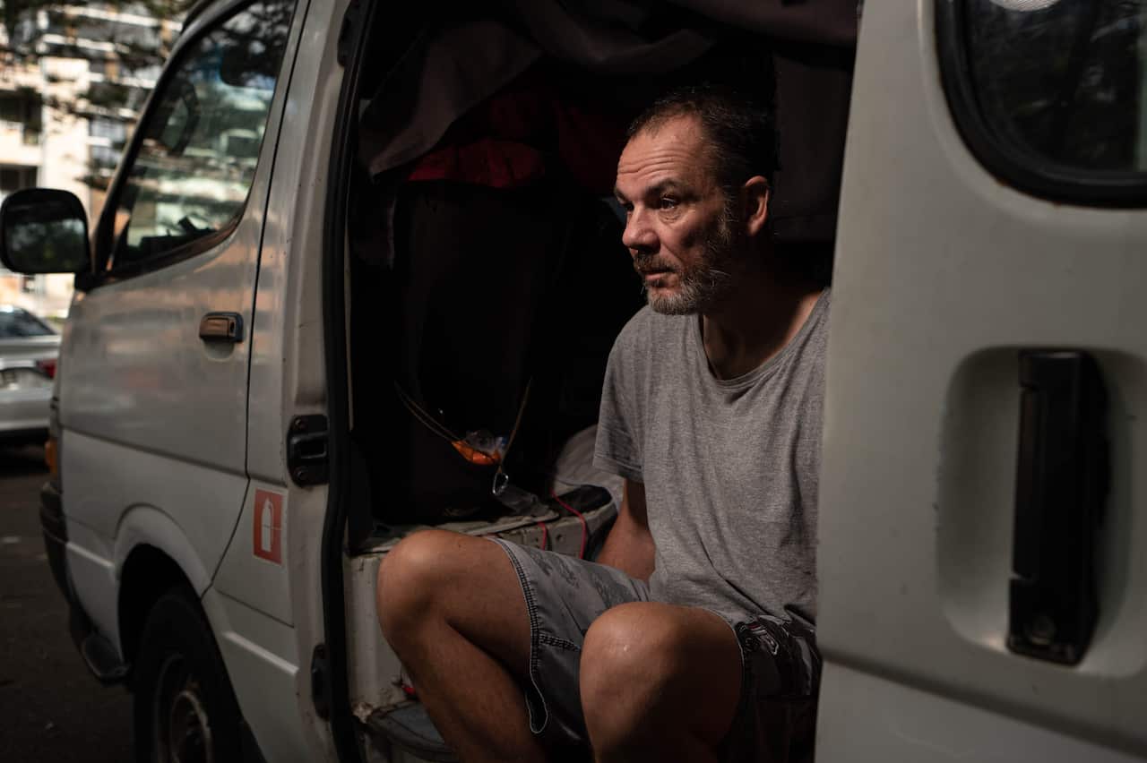 Homeless man Sean Pearce, 50, sits in his van in Sydney's Dee Why library carpark. 