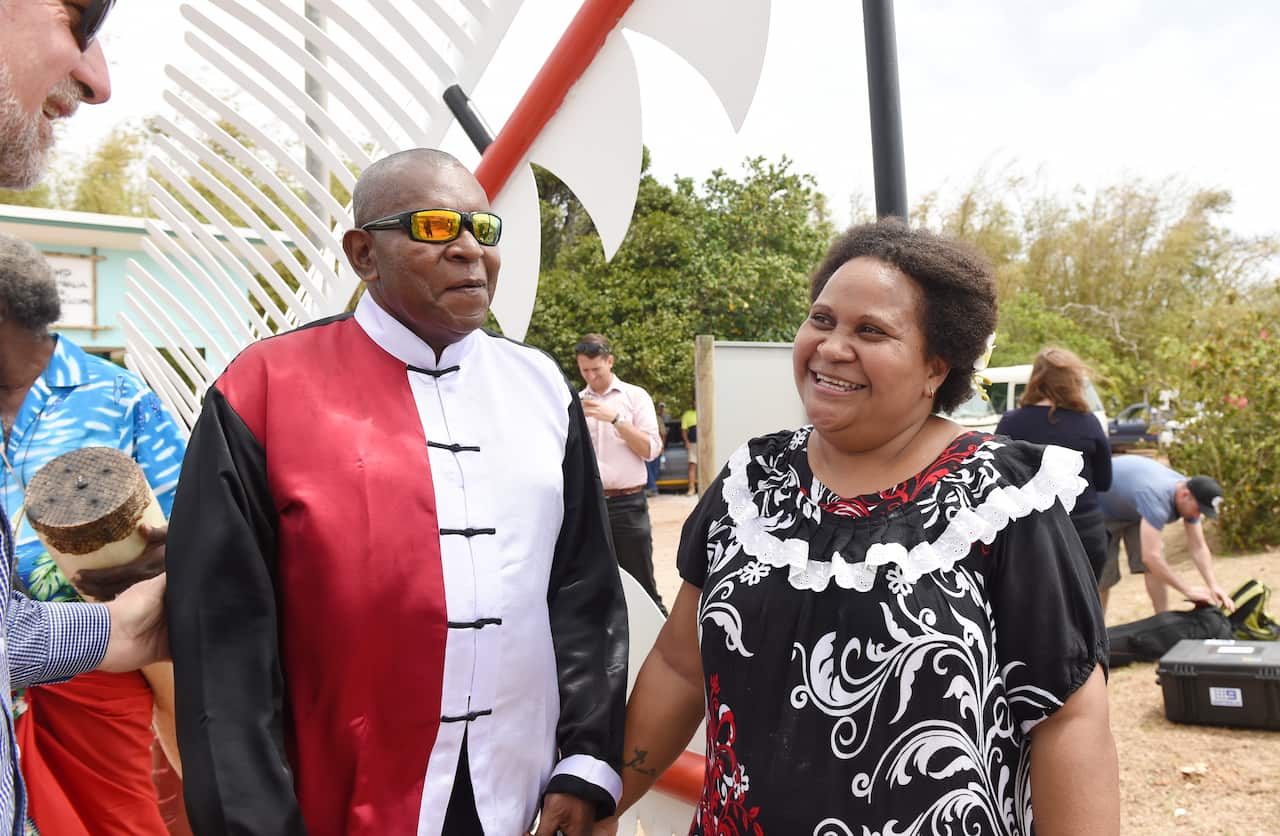 A man and a woman standing outside