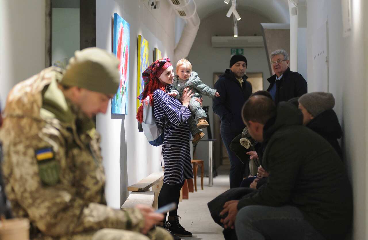 Ukrainians, including a mother and toddler, are huddled in a bomb shelter in Lviv, Ukraine.