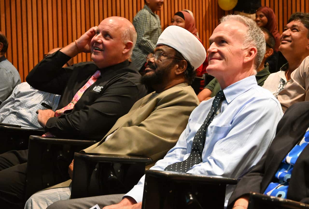 A group of people sitting in a lecture theatre.
