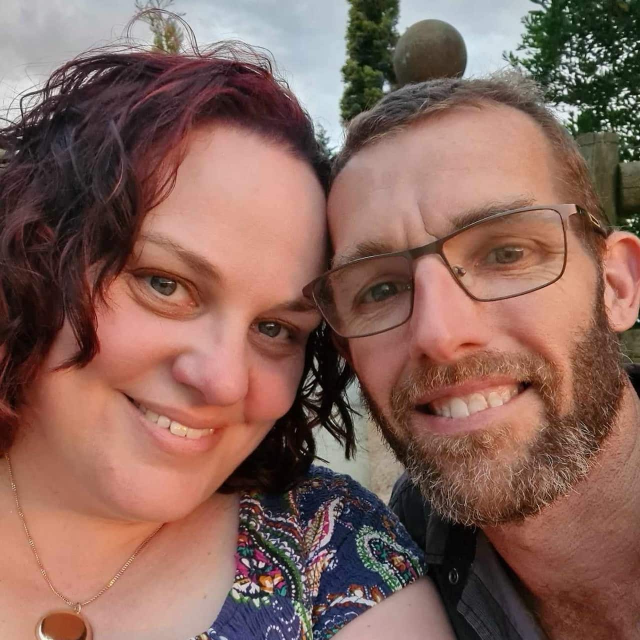 A woman and man pose for a selfie