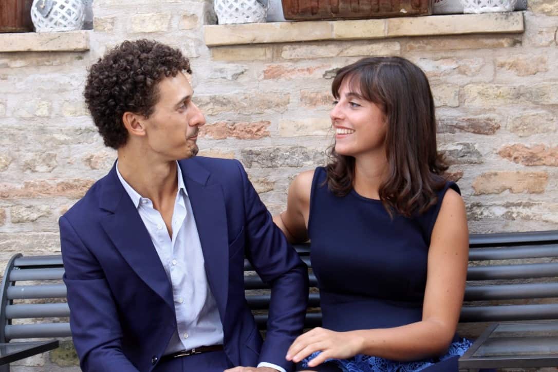Woman and man sitting down, looking into each others eyes.