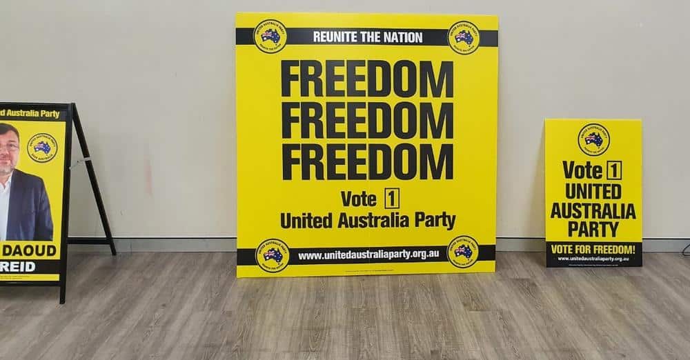 Black and yellow signs against a wall.