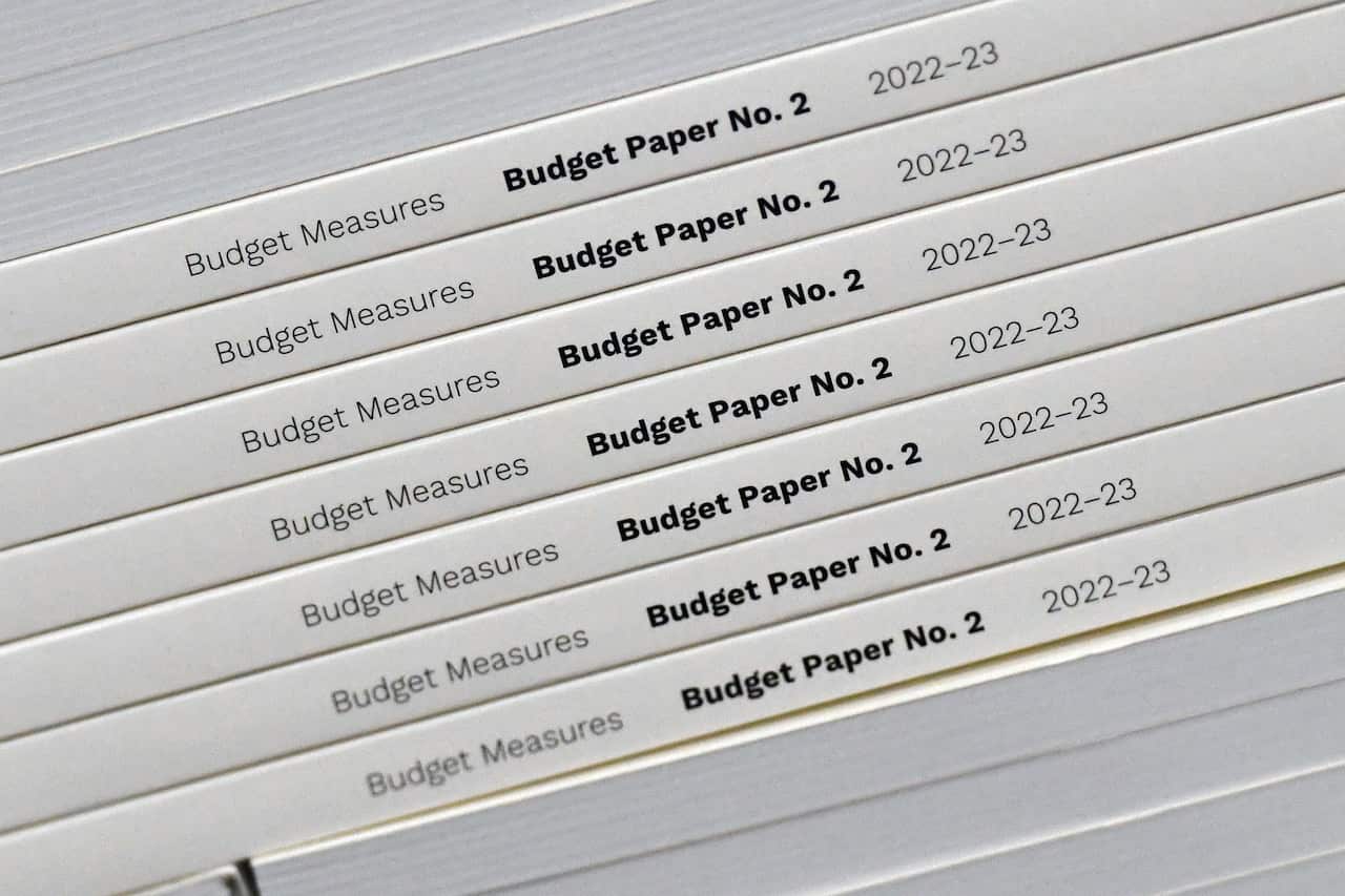 A stack of books. The spines read: "Budget Paper No. 2: Budget Measures 2022-23".