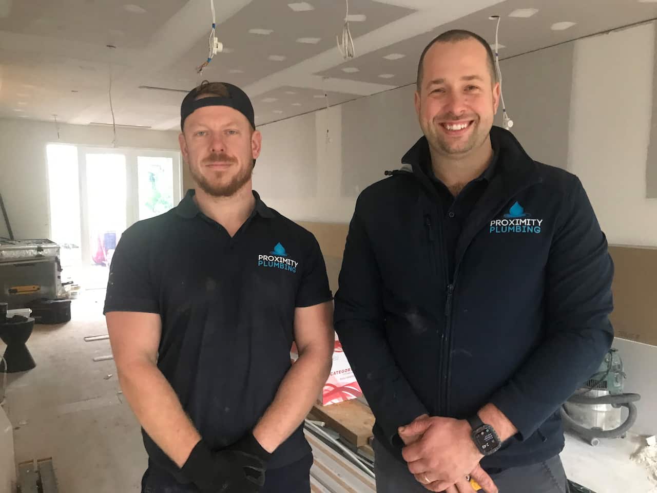 Two employees, Mark and William, from a Sydney based plumbing business are seen at work. 