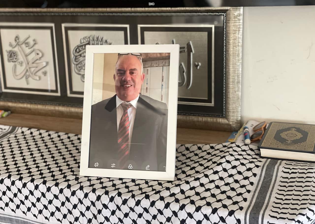 A frame of a man in a suit sits on a table