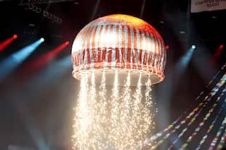 A prop of a teacake on stage with flames coming out of it.
